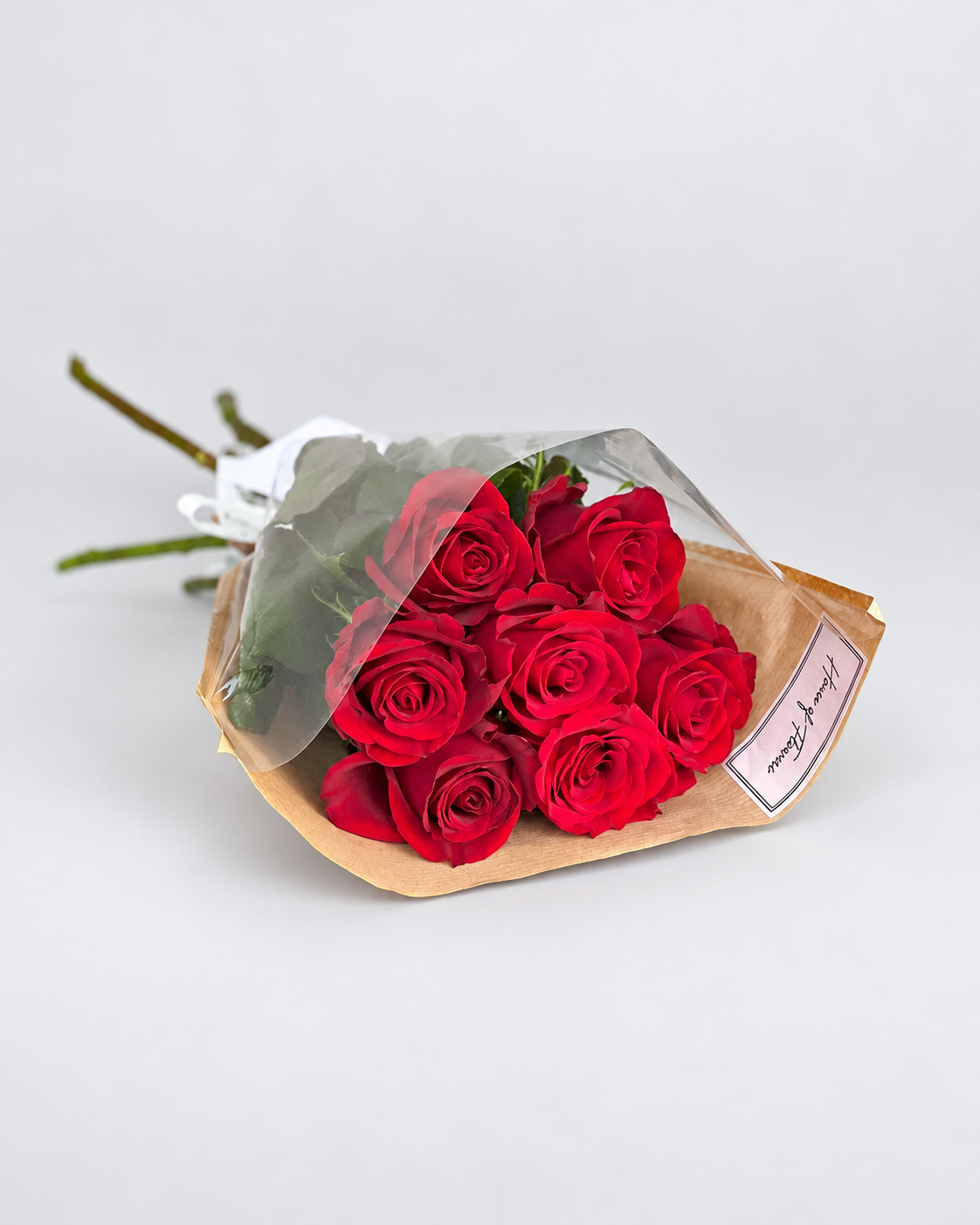 Cherry on Top bouquet of red roses wrapped in kraft paper with a card
