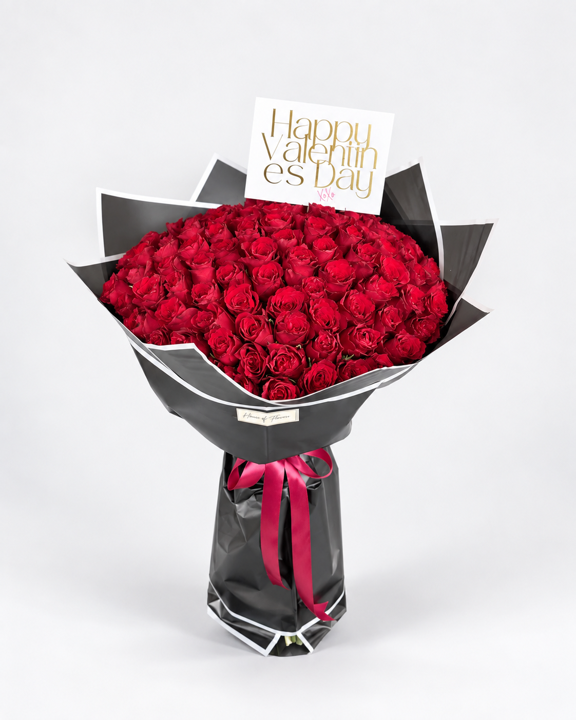 100 red rose bouquet in black wrapping with a satin ribbon and card