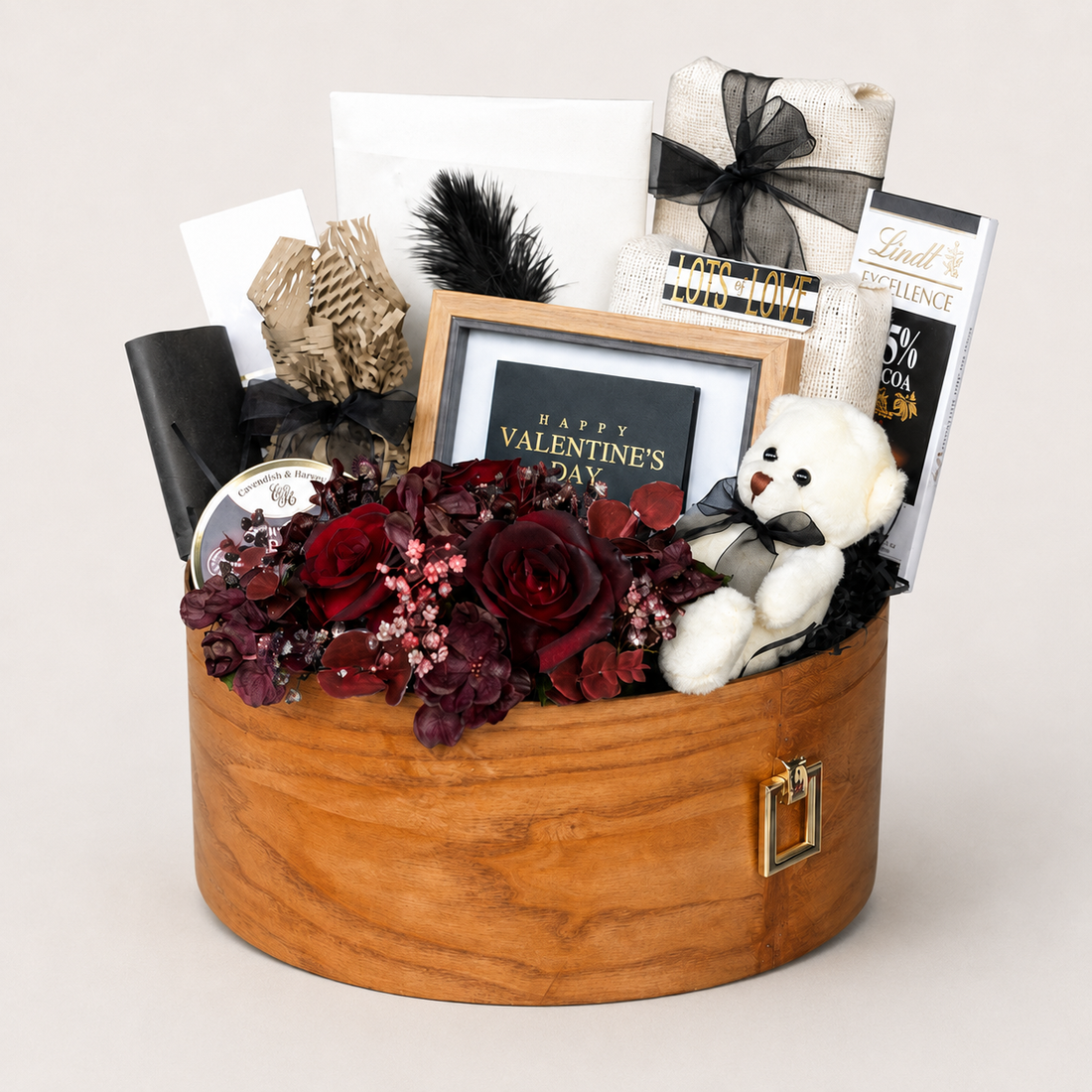 Be Mine gift box with a white teddy bear, dried maroon roses, a feather, and a "Happy Valentine&