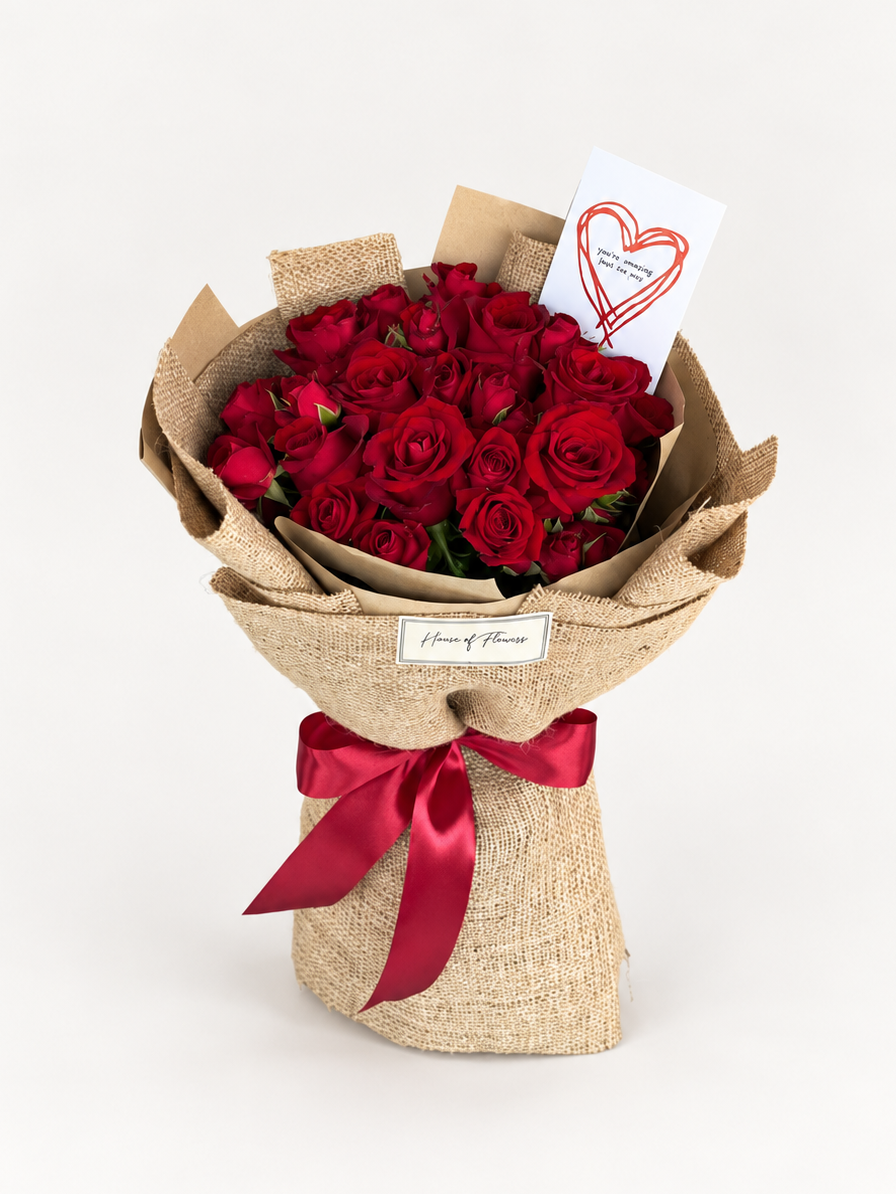 Forbidden Rose bouquet of red roses wrapped in beige burlap paper with a red ribbon and a heart-drawn card