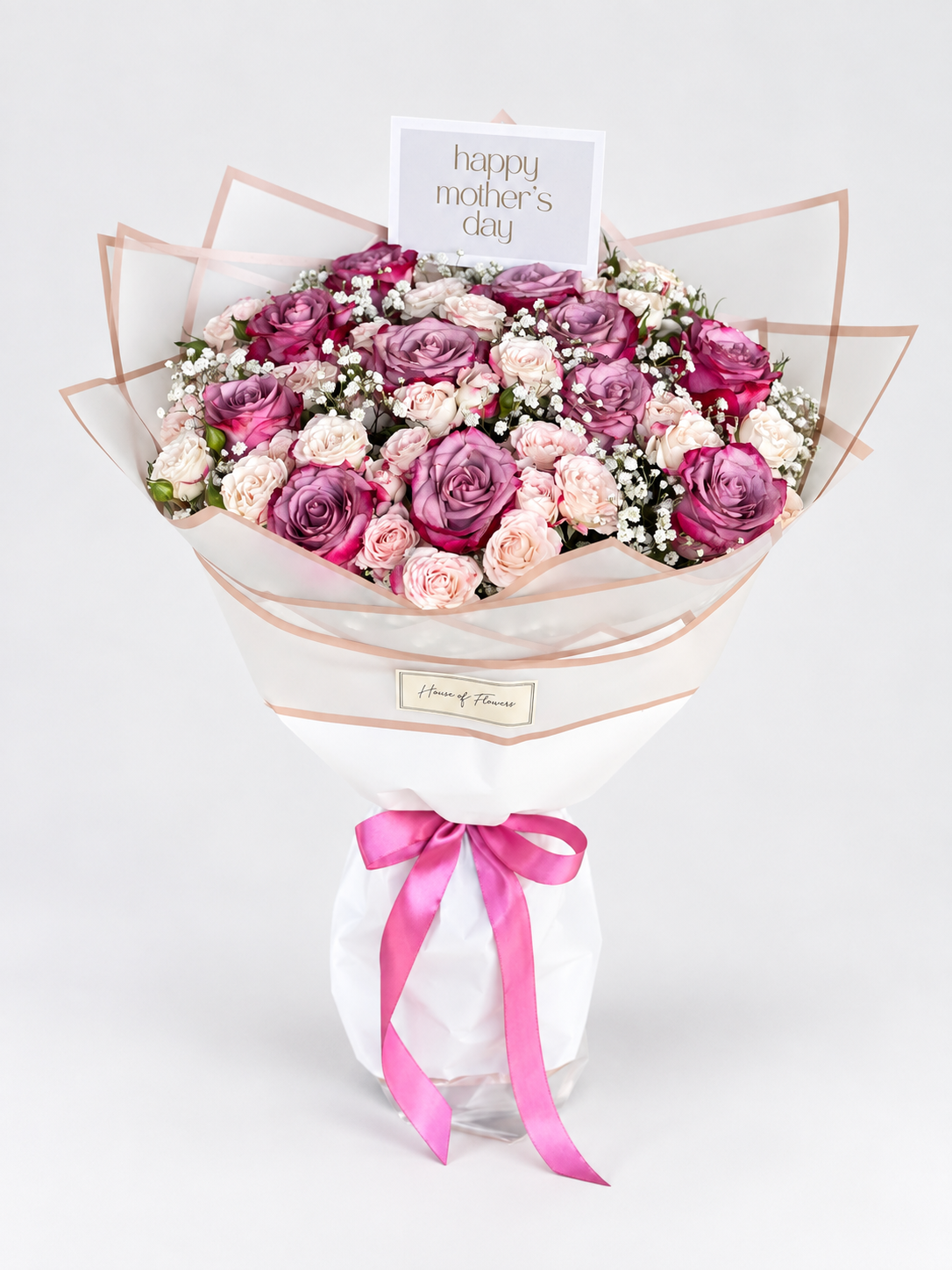 A vibrant flower bouquet featuring pink and purple roses, pink baby&