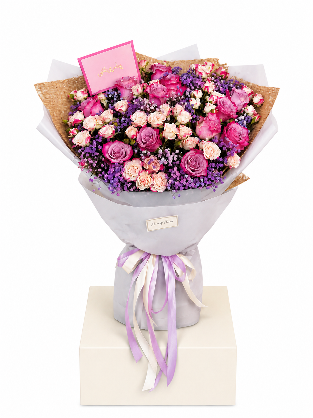 A vibrant flower bouquet featuring pink and purple roses, pink baby&