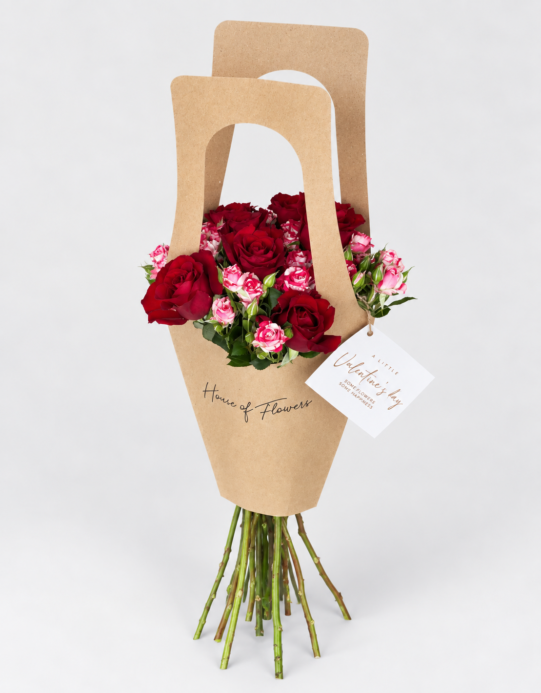 Little Love bouquet of pink and white roses in a kraft paper bag with a card