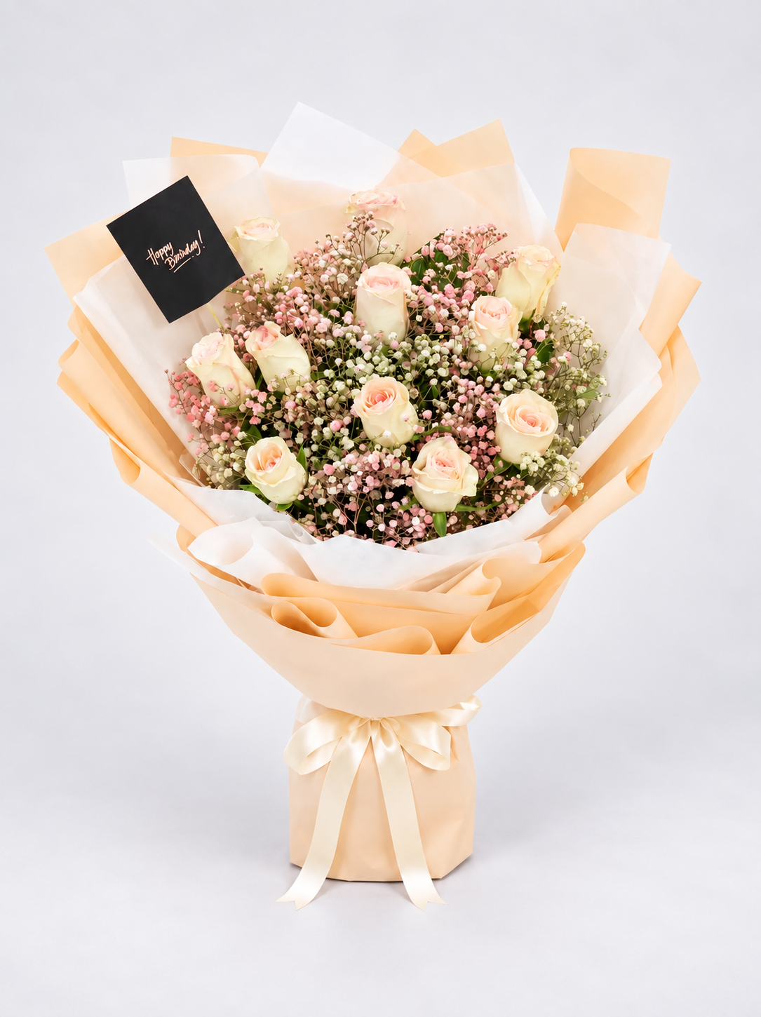 A bouquet of pale pink and cream roses mixed with pink baby&
