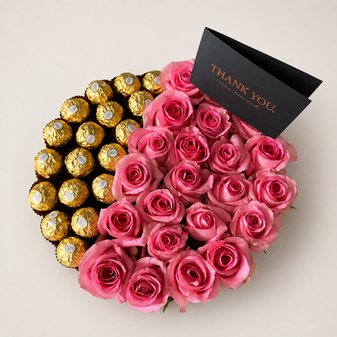 Sweet Affairs arrangement of revival pink roses paired with Ferrero chocolates