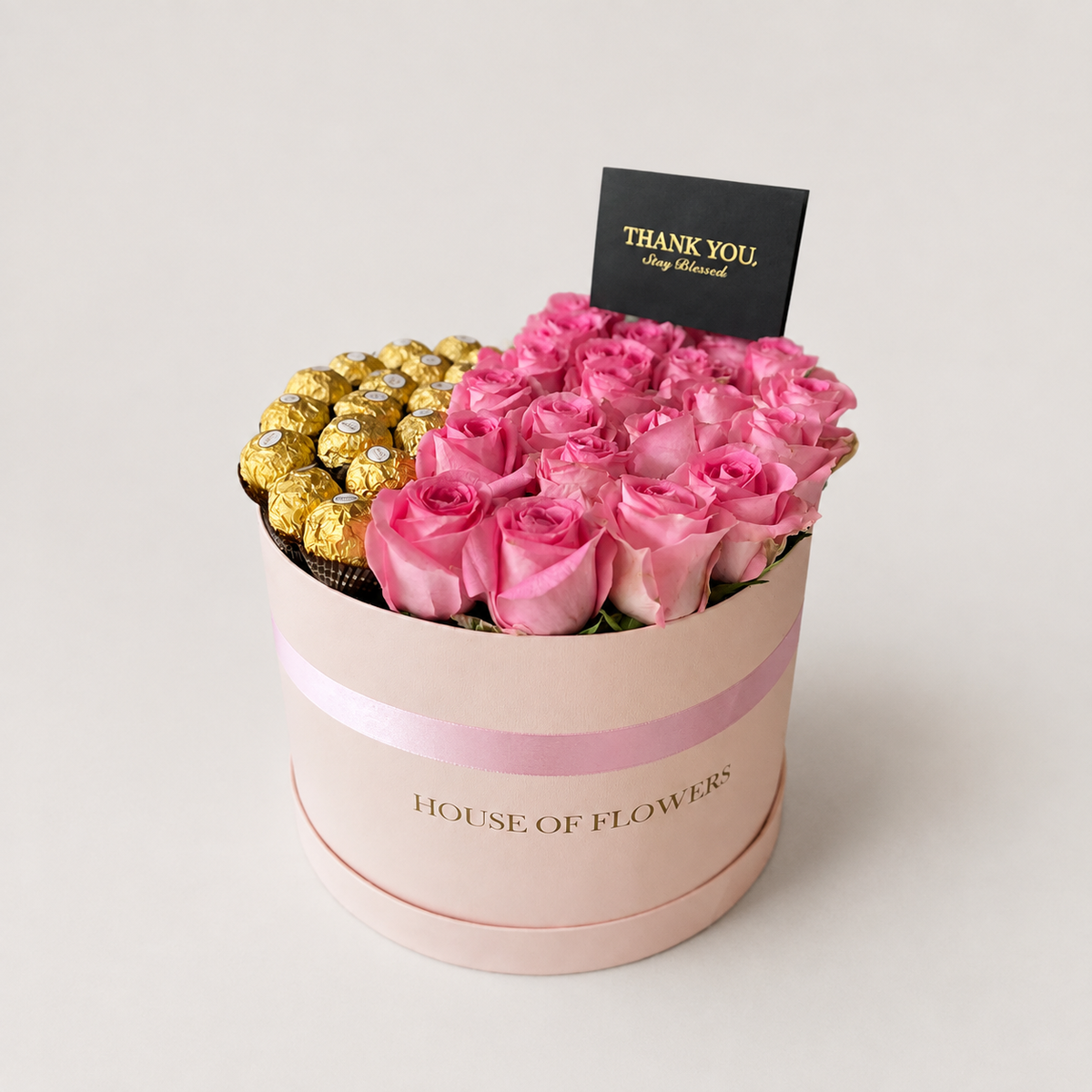 Sweet Affairs arrangement of revival pink roses paired with Ferrero chocolates