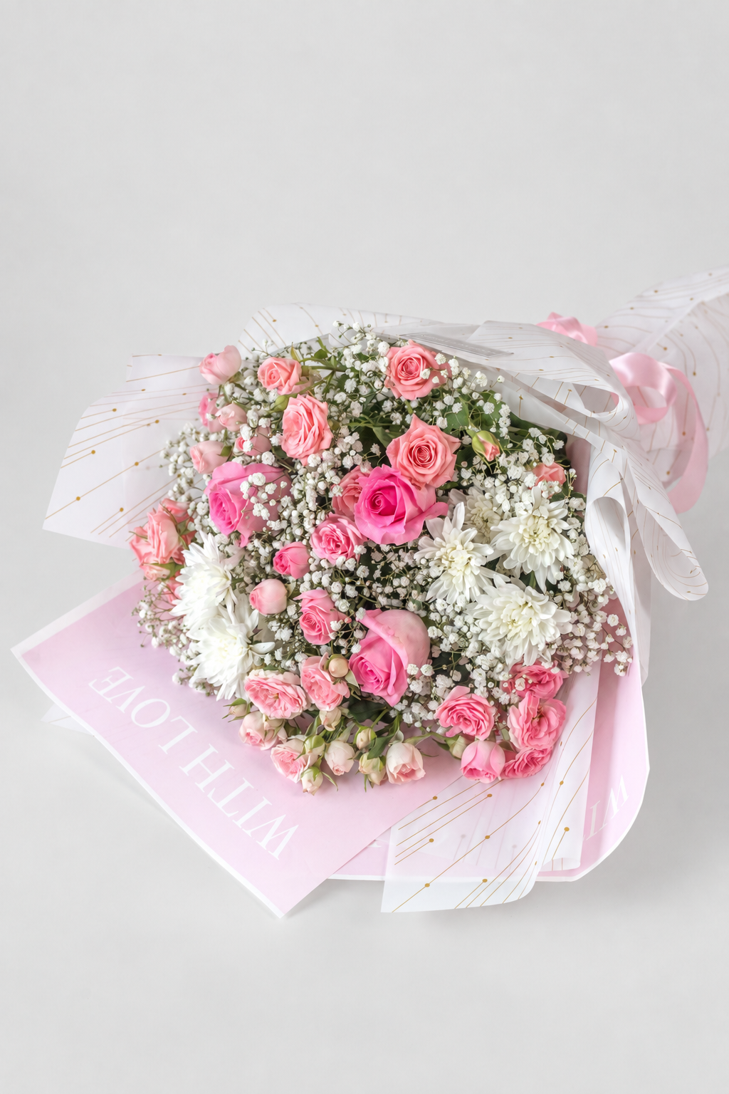 Sweet Pink Symphony bouquet with pink roses, spray roses and white chrysanthemums, wrapped with gypsophila for gifting