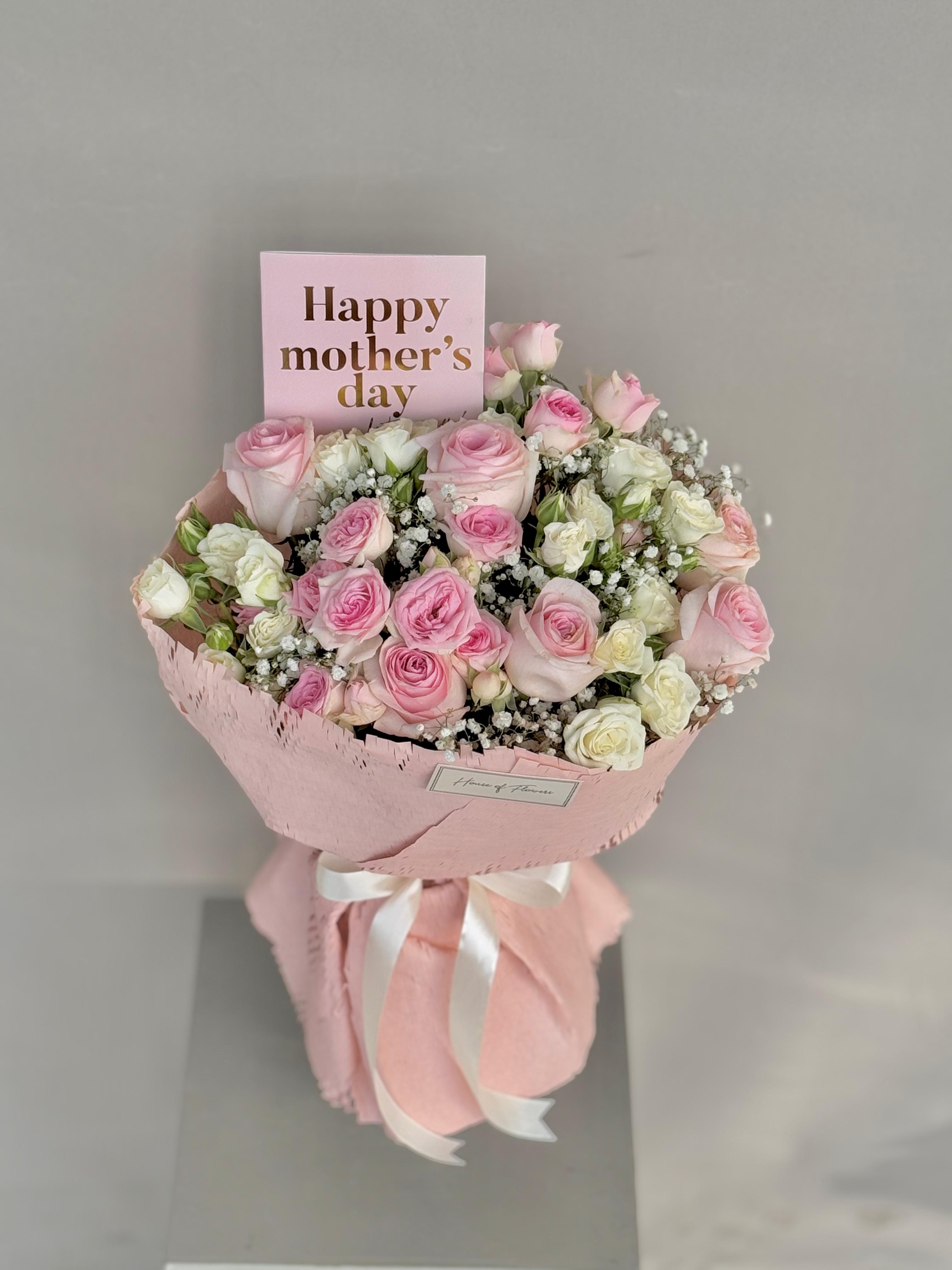Bouquet of pink and white flowers with a &