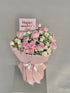 Bouquet of pink and white flowers with a &