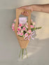 Purely for Her bouquet with pink roses in a kraft paper carrier bag with a "The Best Mom" card and pink ribbon