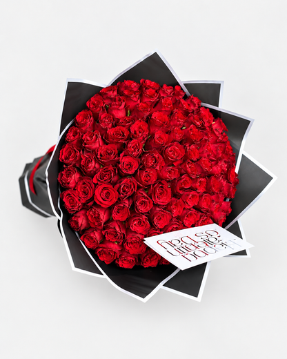 Top view of the 100 Reasons red rose bouquet in black wrapping