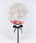 Clear confetti balloon reading Happy Birthday with rainbow confetti and a black ribbon