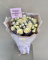 Whispers of Love bouquet with cream roses, lavender and white chrysanthemums, wrapped in kraft and white paper with a "Happy Mother&
