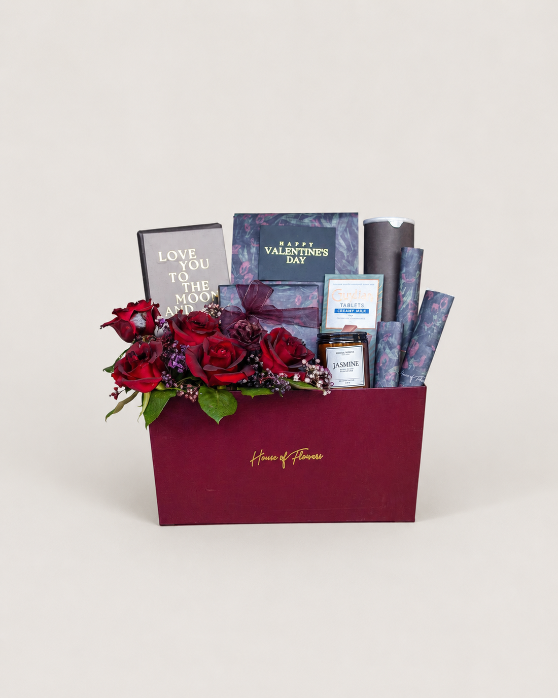 Luxury Valentine’s Day gift box with red roses, blue gift items, and greeting card.