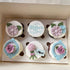 Occasion Luxury Floral Cupcakes with pastel buttercream icing in a clear gift box