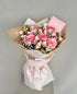 Bouquet of pink roses with a card on a gray background