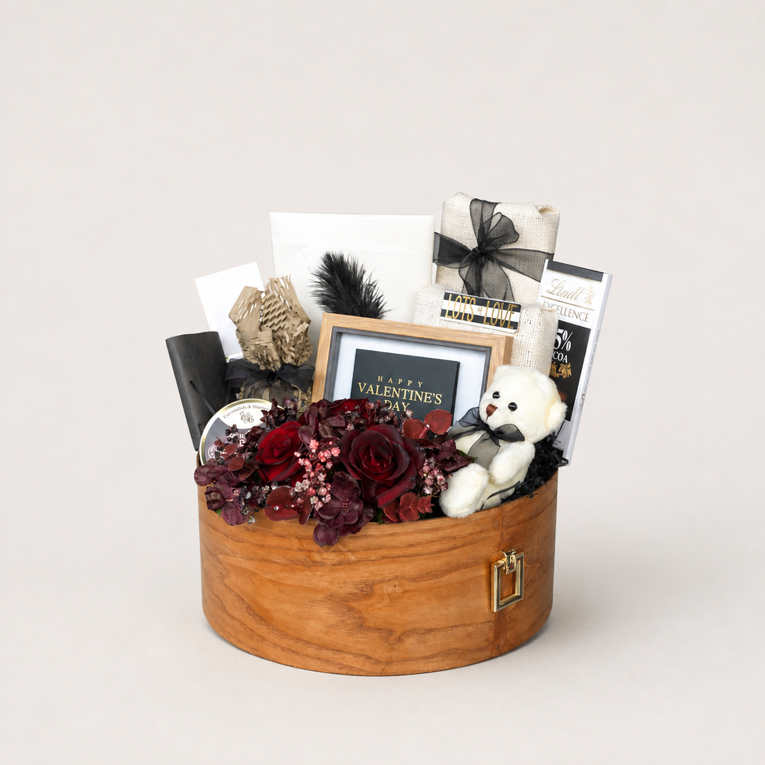 Be Mine gift box with a white teddy bear, dried maroon roses, a feather, and a "Happy Valentine&