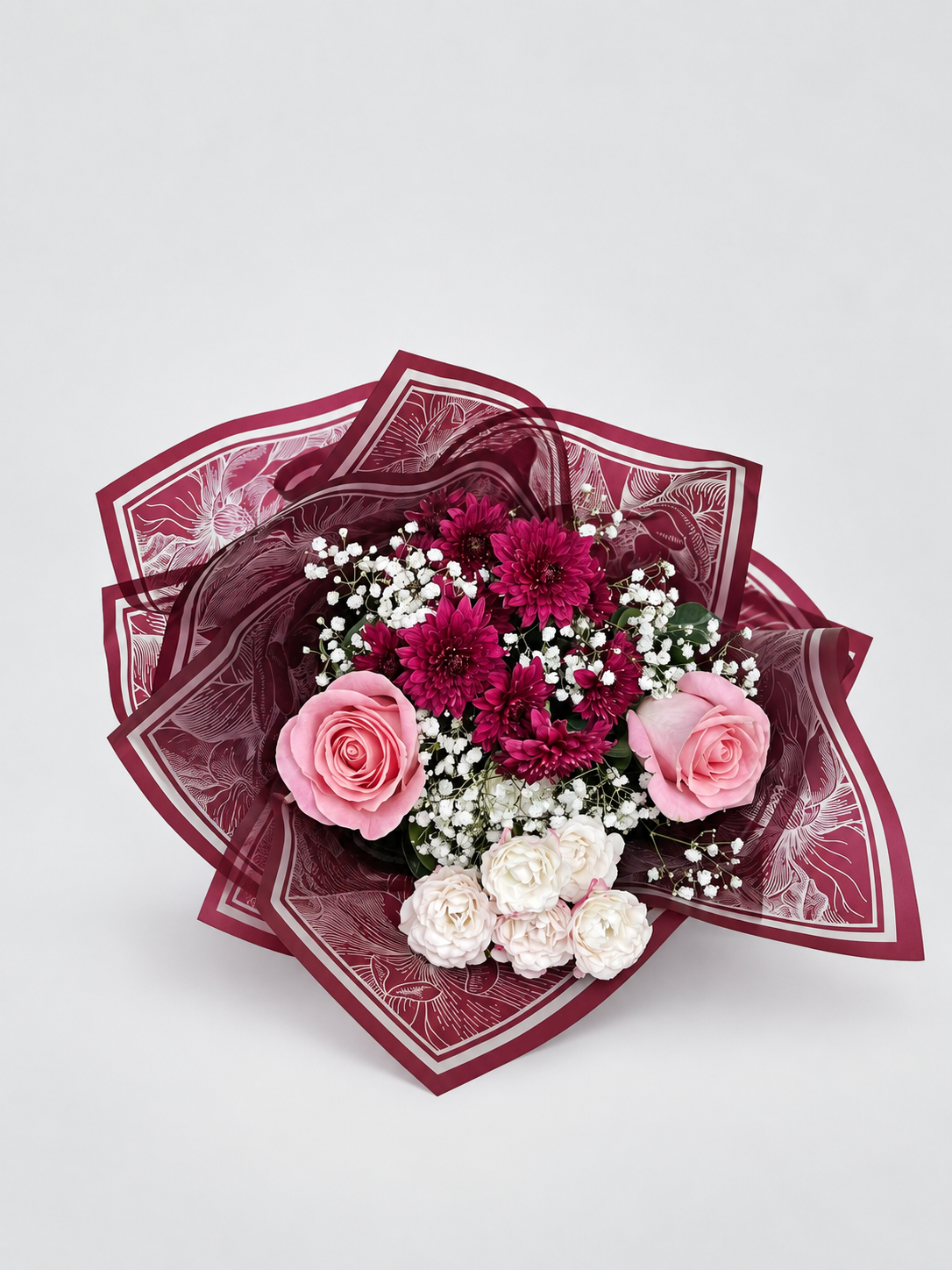 a cute bouquet with a mixture of roses and chrysanthemums wrapped in a premium wrapping sheet.