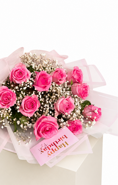 A bouquet of pink roses and white baby&