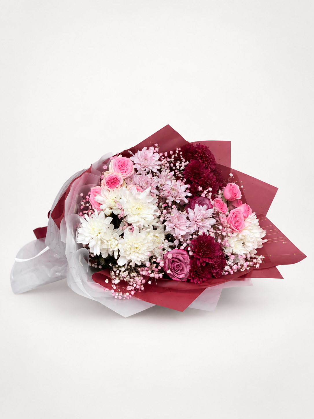 A floral bouquet featuring white and pink flowers, including roses, chrysanthemums, and baby&