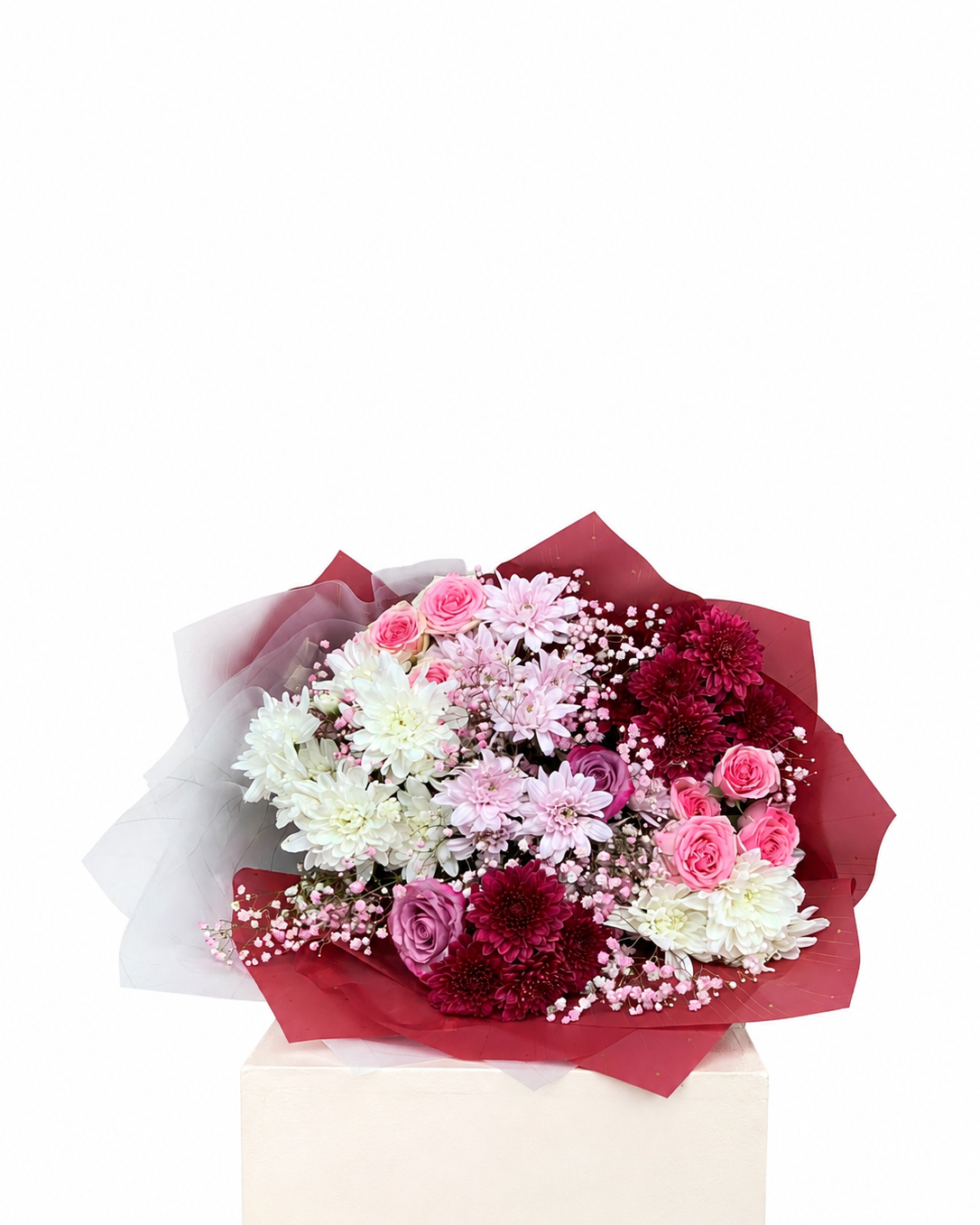 A mixed flower bouquet featuring pink and white roses, burgundy chrysanthemums, and baby&