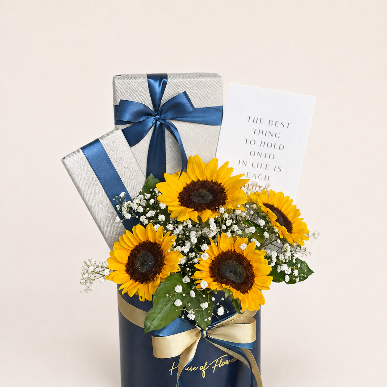 A floral gift arrangement featuring sunflowers, baby&