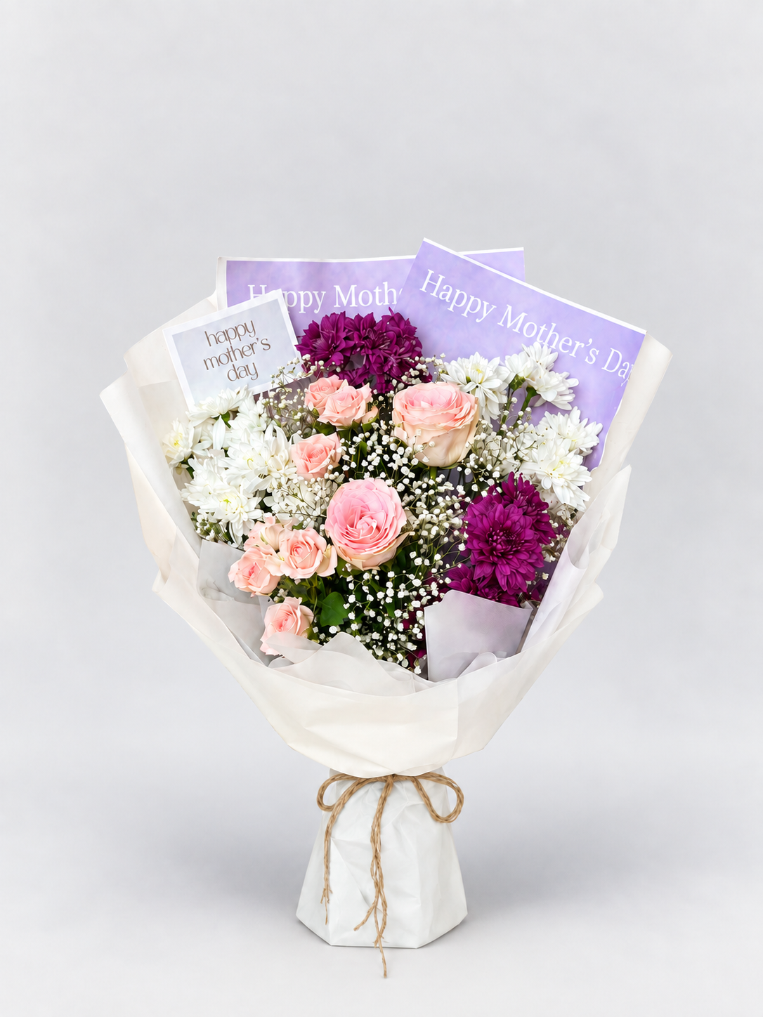 A bouquet  of maroon chrysanthemums, white chrysanthemums , roses and spray roses.
