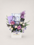 Eid Lumé gift box with purple and white roses, lavender, and wrapped Eid gifts