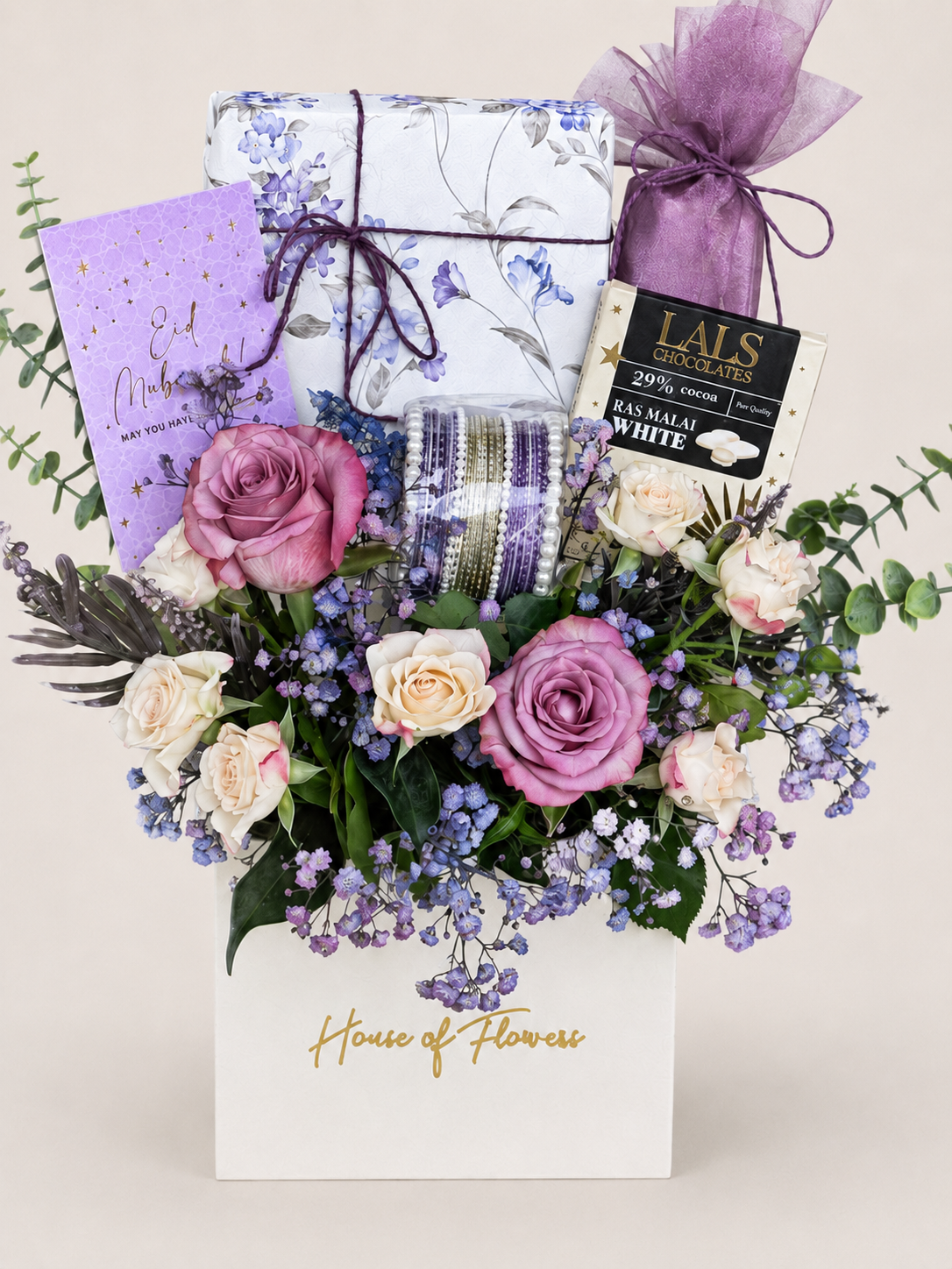 Eid Lumé gift box with purple and white roses, lavender, and wrapped Eid gifts