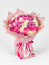 A bouquet of fresh roses, featuring a mix of pink, purple, and white roses, wrapped in yellow and clear paper with a pink ribbon.