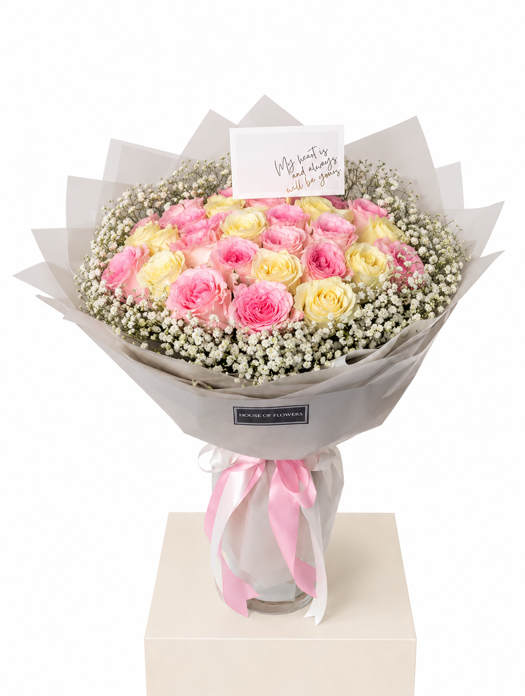 A bouquet of pink and yellow roses with white baby&