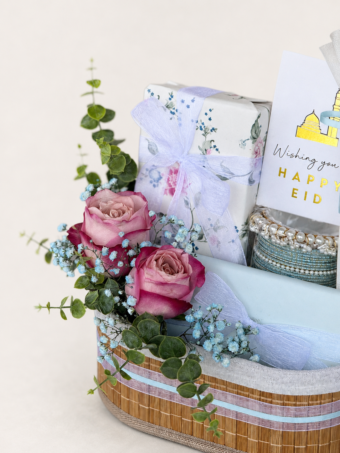 Garden blush gift basket with pink roses and Happy Eid card arrangements.