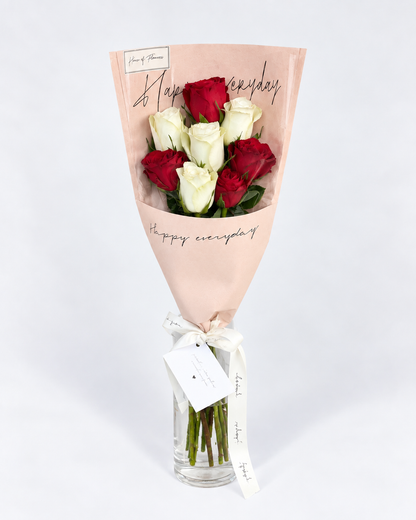 Heart Stopper rose bouquet in red and white, arranged with a message card