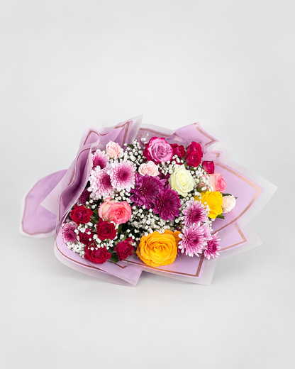 a vibrant flower bouquet with a mixture of different flowers like chrysanthemums, spray roses and roses.