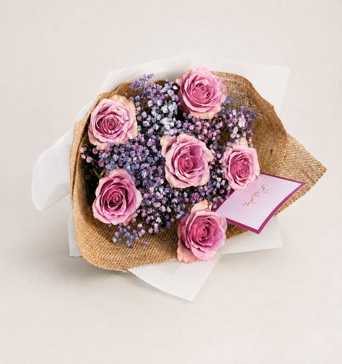 A bouquet of pink roses and purple baby&