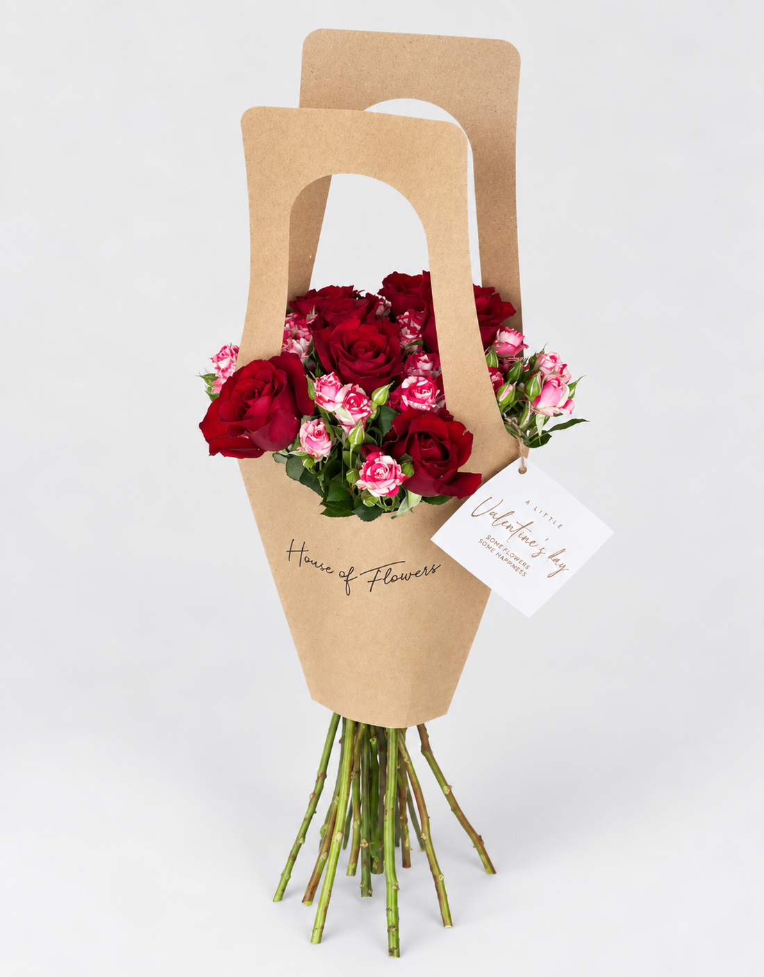 Little Love bouquet of pink and white roses in a kraft paper bag with a card