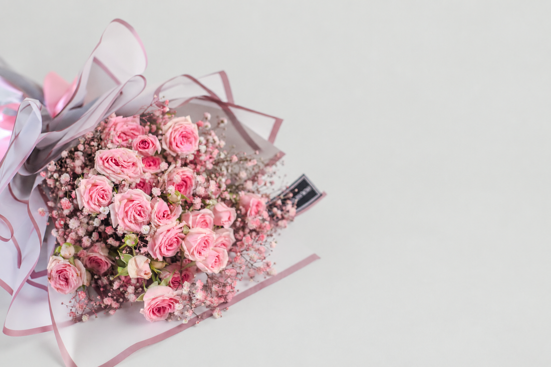 the bouquet includes spray roses and babys breath.