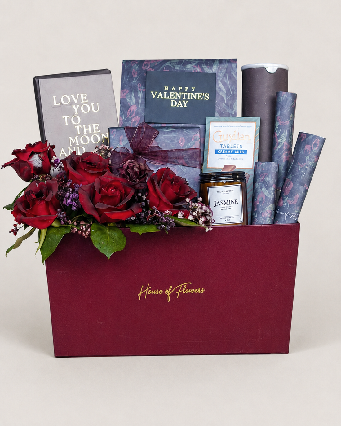 Luxury Valentine’s Day gift box with red roses, blue gift items, and greeting card.