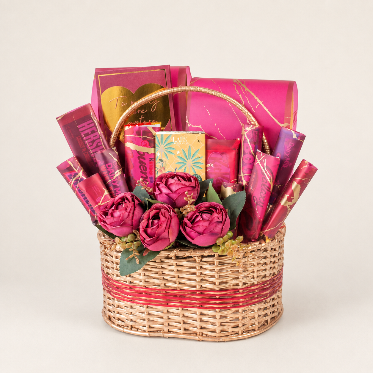 Pink Divia gift box filled with assorted chocolates, snacks, and artificial flowers