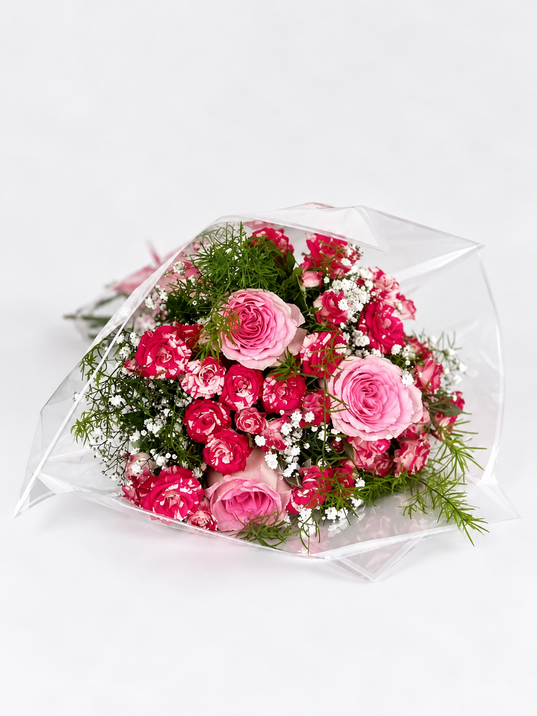 Bouquet of pink and green flowers in clear plastic wrap