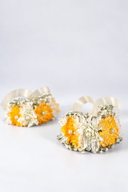 Pair of fresh flower gajras with yellow chrysanthemums, white blooms and pearls on ribbon ties