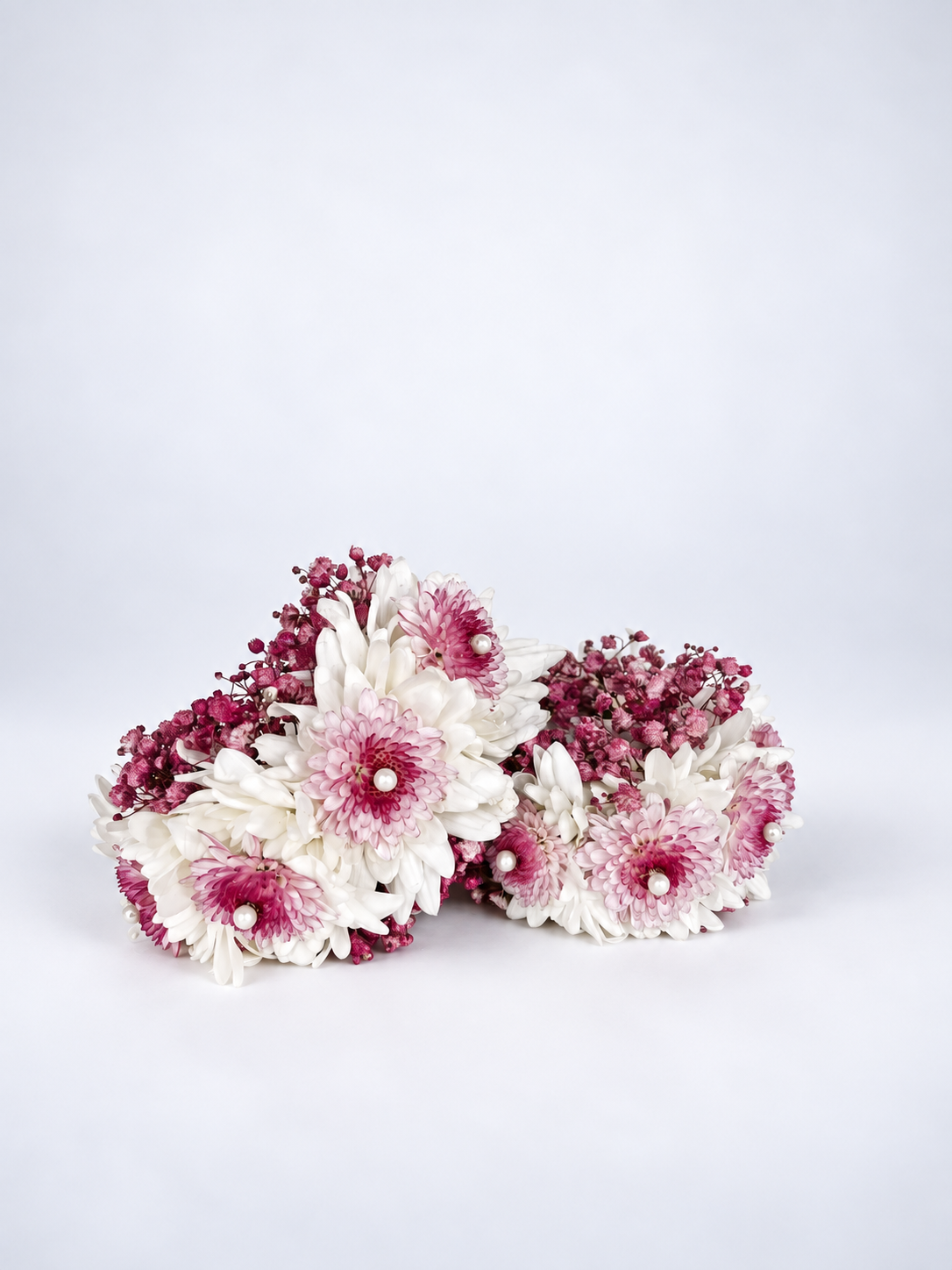 Pink-shaded flower gajras with white and magenta blooms