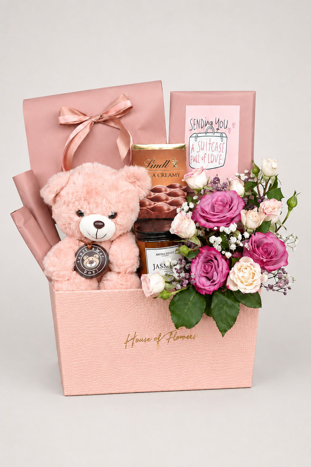 this basket includes different chocolates, candle and a teddy