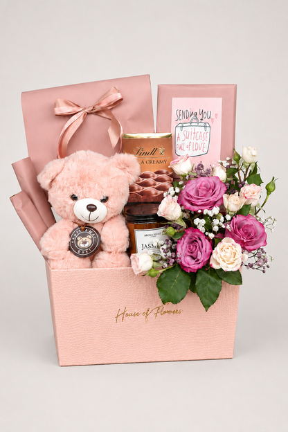 this basket includes different chocolates, candle and a teddy