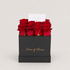 A gift box of 12 red roses in a square kraft paper box with &