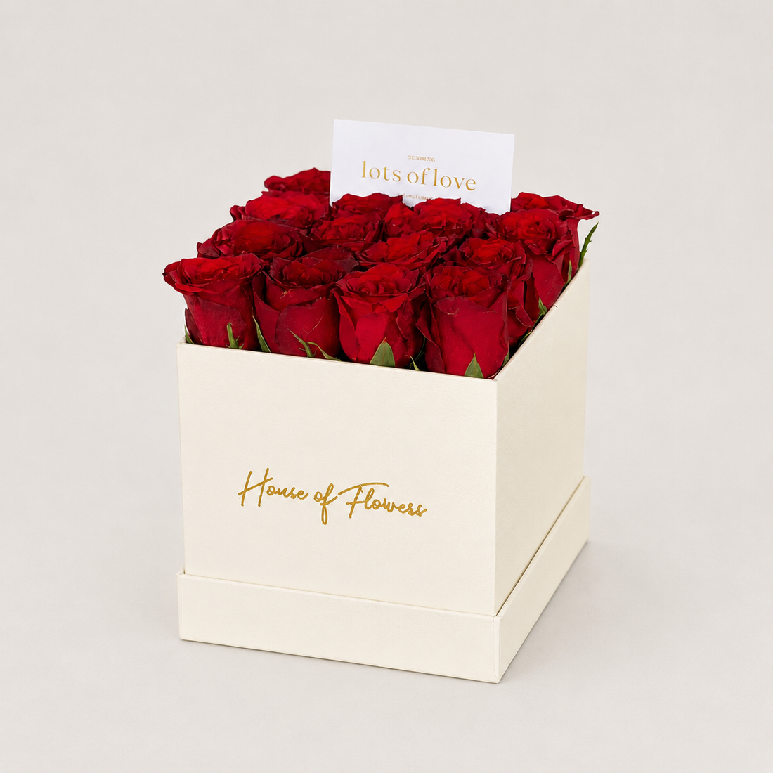 A gift box of 12 red roses in a square kraft paper box with &