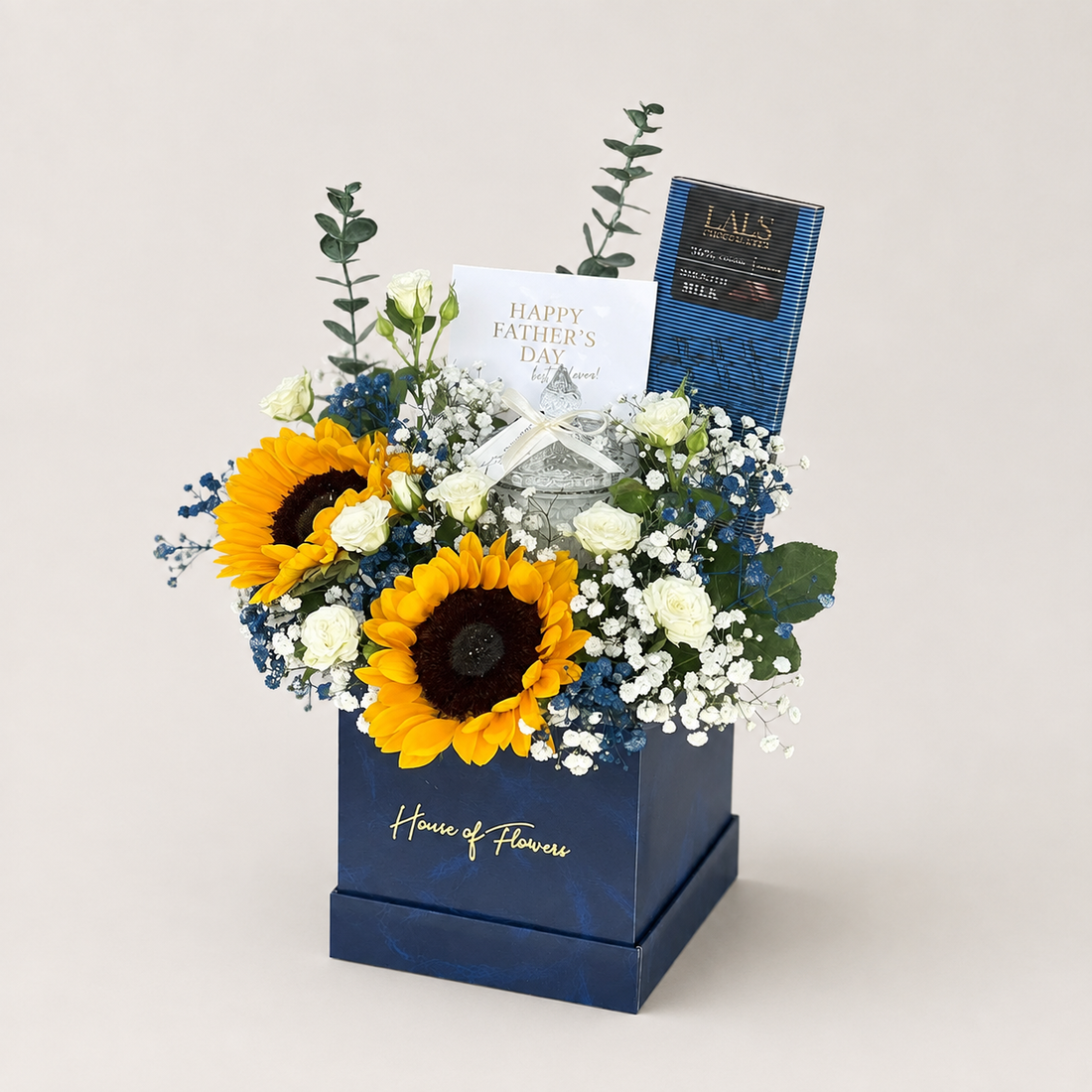 Shine on Dad gift box featuring two sunflowers, two spray roses, gypso, artificial fillers, a Lals chocolate bar, candle jar, and greeting card.
