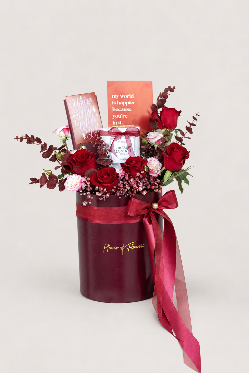 Red cylinder gift box arrangement featuring 5 imported red roses, pink-shaded spray roses, baby&