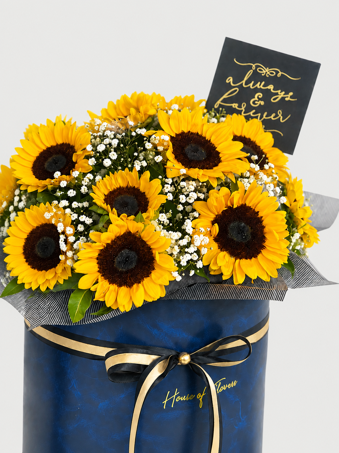 A bouquet of bright yellow sunflowers with dark brown centers, mixed with small white baby&