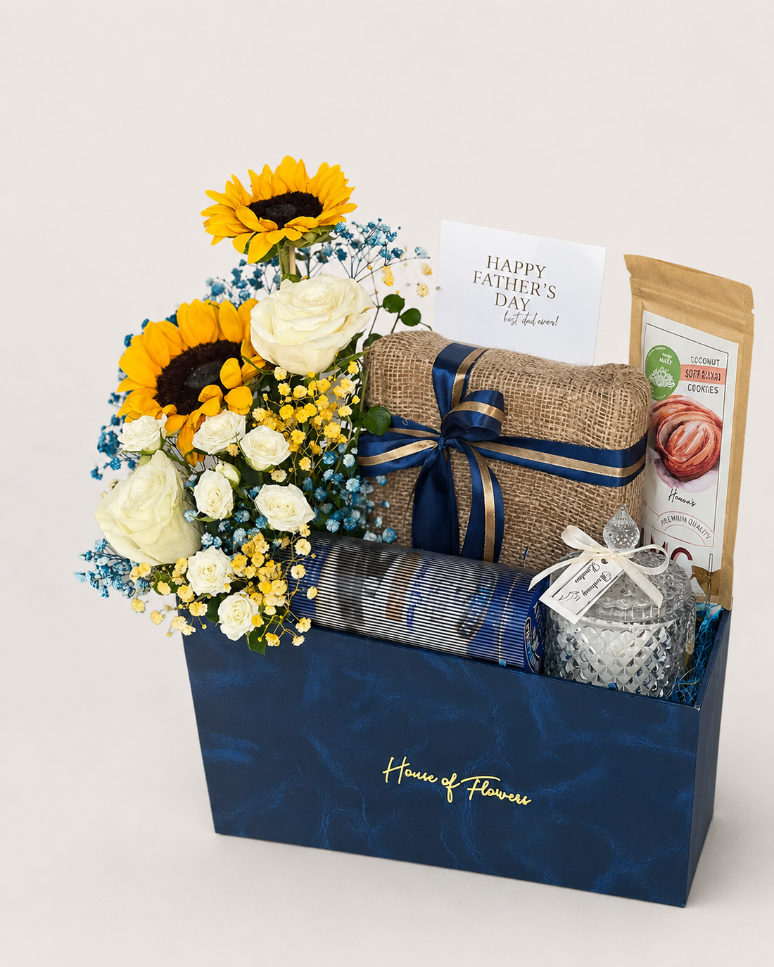 Sunlight & Strength gift box with sunflowers, roses, gypso, almonds, cookies, chocolate, a candle, wafers, and greeting card.